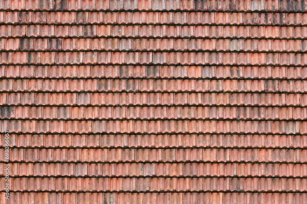 Close up of red terracotta roof shingles with some mildew. Background texture of old roofing material Close up of red terracotta roof shingles with some mildew. Background texture of old roofing material