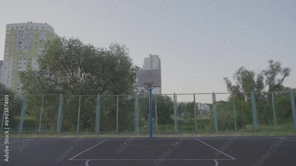 custom made wallpaper toronto digitalOld sports ground with basketball hoop against trees and residential building. City life and entertainment concept. Active pastime for residents