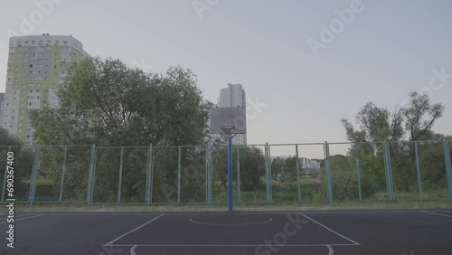 Wallpaper Mural Old sports ground with basketball hoop against trees and residential building. City life and entertainment concept. Active pastime for residents Torontodigital.ca