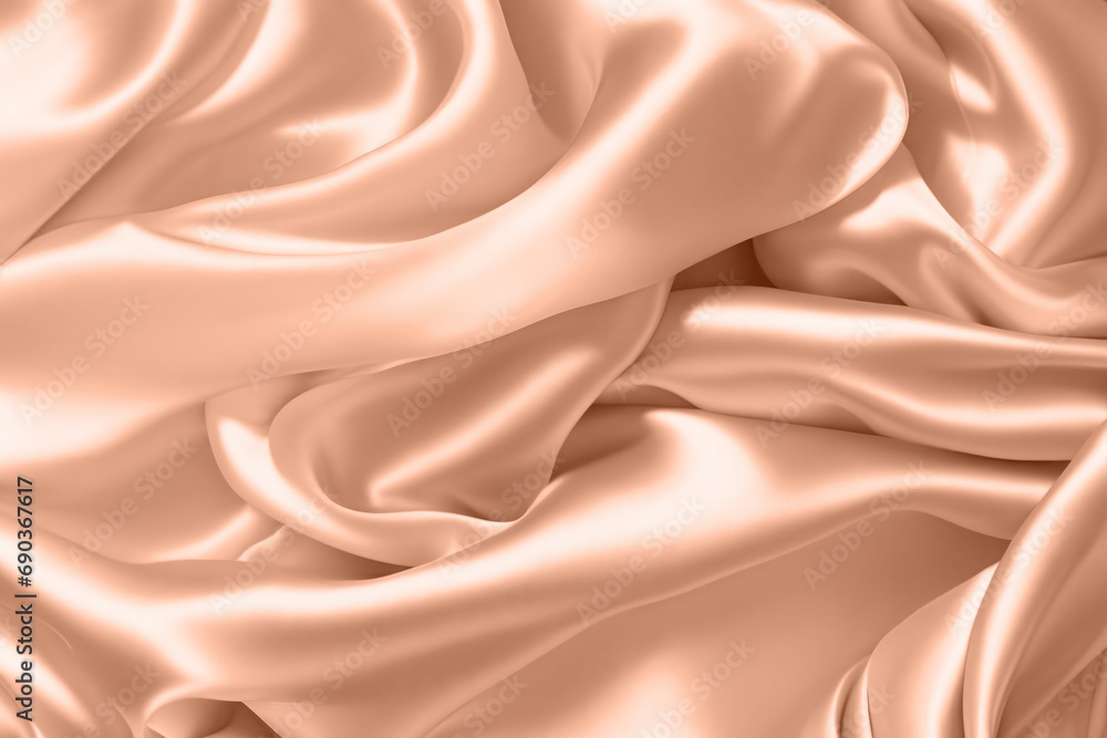Fototapeta premium Abstract background, folds of silk fabric in peach fuzz color.