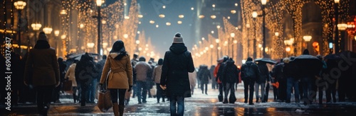 people walking down a city street at night