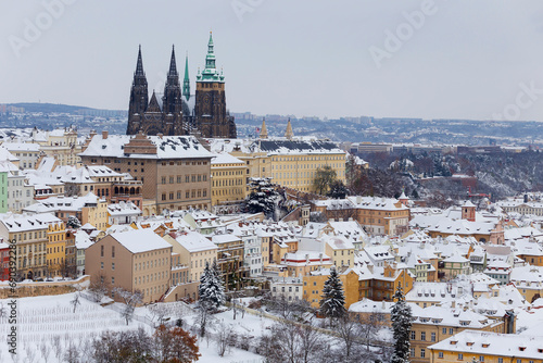 Snowy Prague City with gothic Castle from the Hill Petrin, Czech republic
