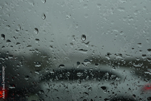 photo of blurred city behind car window, blurred city behind car window in the rain photo