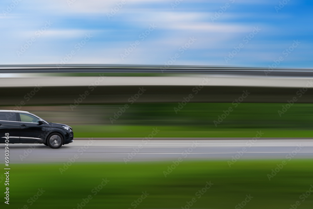 Obraz premium Car on speed blurred background. Driving car with free space for text, copy space. Car concept, car themed picture