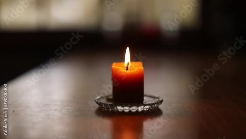 Single beeswax candle burning. photo