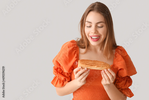 Pretty young woman with tas...