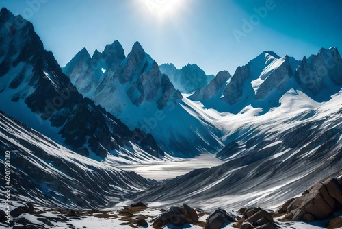 A panoramic view of a mountain range under a clear blue sky