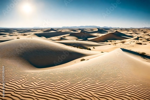 A vast desert landscape with towering sand dunes under a clear blue sky