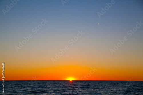 Tranquil Sunset Seascape with Crescent Moon over Lake Michigan