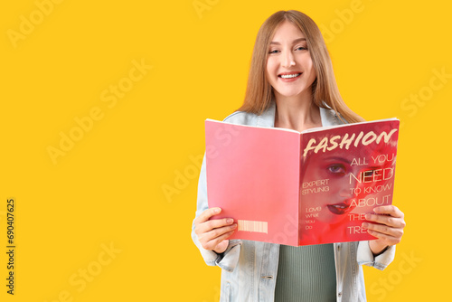 Smiling young woman reading...