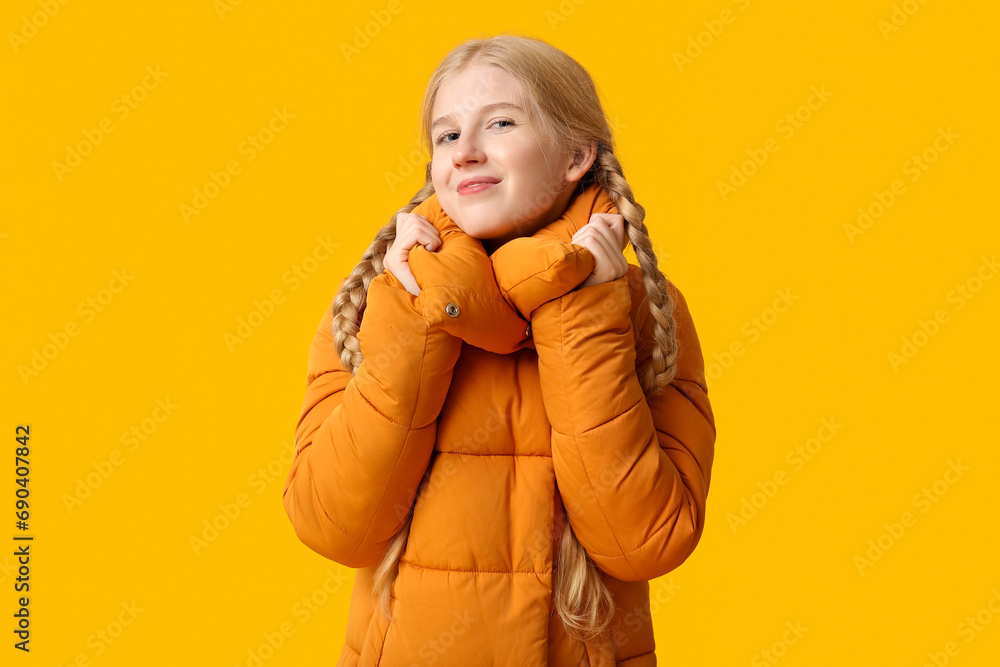 Beautiful young happy woman in warm winter clothes on yellow background Beautiful young happy woman in warm winter clothes on yellow background