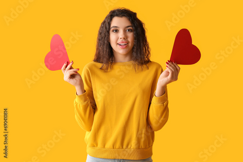 Young woman holding two red...
