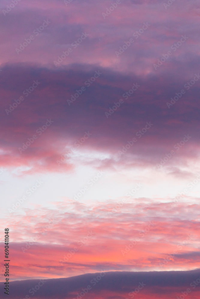 Sunset in the clouds. Colorful dramatic sky. Pastel graduated pink, purple and blue background. 