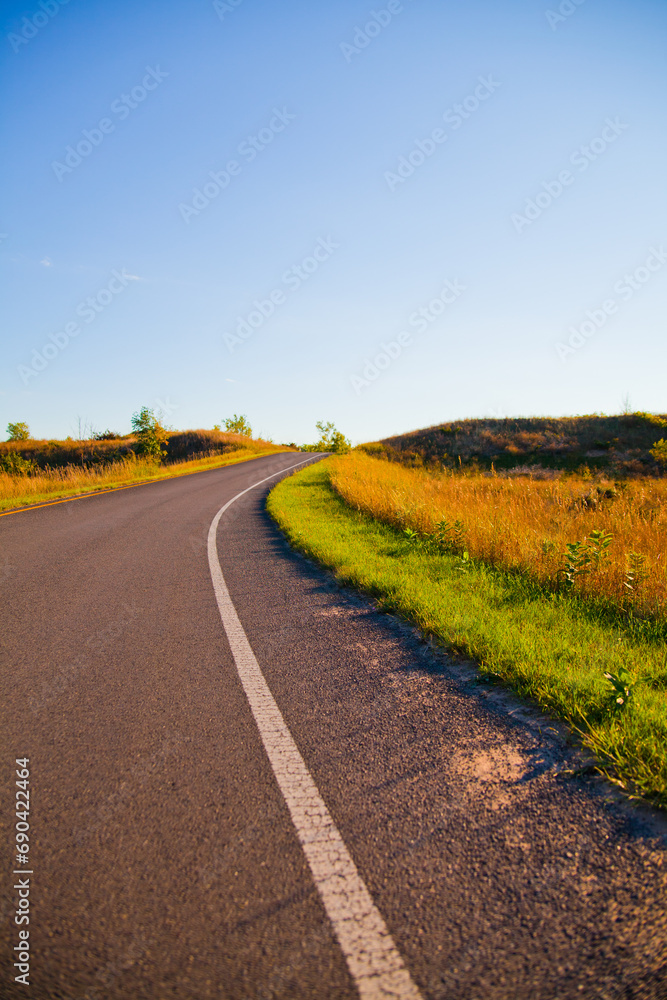 Naklejka premium Golden Hour on Edge of Serene Michigan Country Road