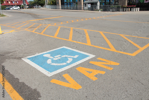 van handicap parking space with van written text below handicap symbol, road in background