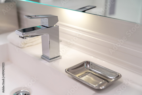 Fotografie Modern sink faucet and soap dish in a hotel bathroom