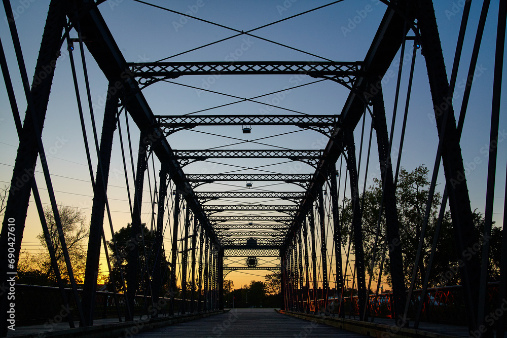 Fototapeta premium Golden Hour Glow on Wells Street Truss Bridge, Silhouette in Fort Wayne