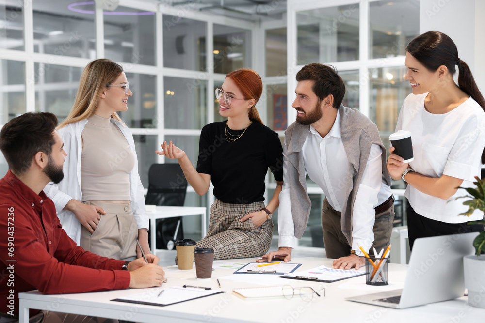 Team of employees working together in office Team of employees working together in office