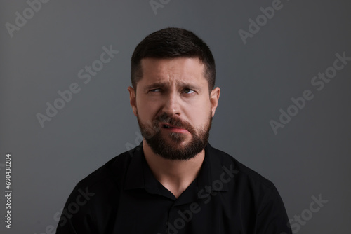 Personality concept. Emotional man on grey background