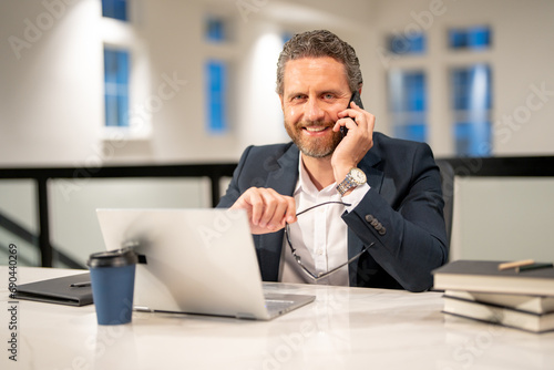 Business man entrepreneur startup owner in modern office. Occupation person in work space. Business portrait. Confident business worker. Business man talking on phone at office workplace.