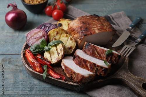 Delicious grilled meat and vegetables served on wooden table, closeup