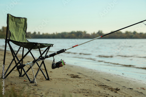 Folding chair and fishing rod at riverside