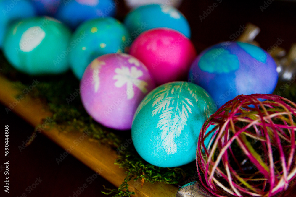 Fototapeta premium Vibrant Collection of Hand-Painted Easter Eggs on Wooden Surface