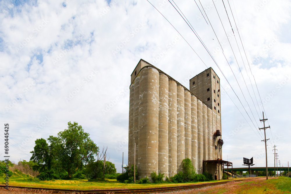 Abandoned Industrial Silo and Power Lines in Illinois Landscape