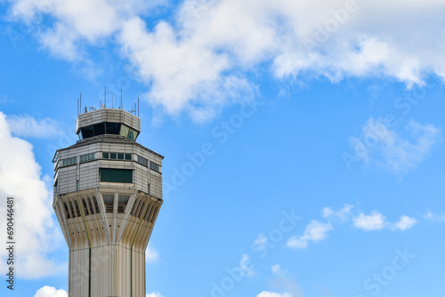 Fotografie Airport traffic control tower with clouds and blue sky background