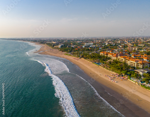 Aerial view of Seminyak beach coastline. The famous and luxury Kuta beach resort in southern Bali, Indonesia. Sunny day drone photo