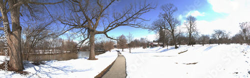 Panoramic Winter Solitude with Snowy Pathway, Leafless Trees, and Tranquil River