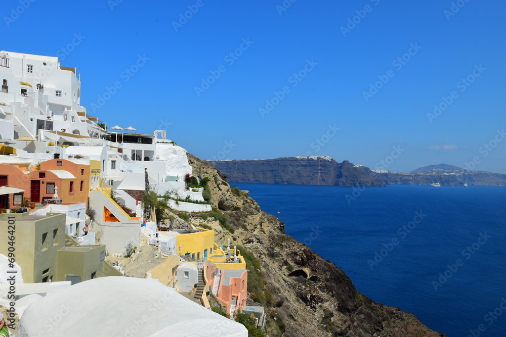 June 18, 2023: Ferry passing the calderea of Fira, Santorini, Cyclades, Greek Islands, Greece, Europe. This was on a sunny day with a clear horizon in this stunning and picture perfect Greek Island.