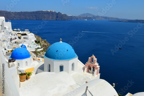 SANTORINI,GREECE-June 20 2023: Oia village, the most picturesque village on Santorini island, a famous touristic resort in the Cyclades islands, Aegean sea, Greece, Europe. This was on a hot sunny day