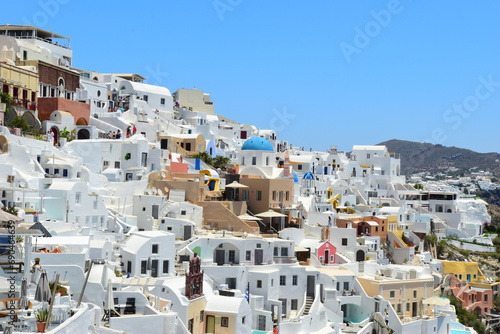 SANTORINI,GREECE-June 20 2023: Oia village, the most picturesque village on Santorini island, a famous touristic resort in the Cyclades islands, Aegean sea, Greece, Europe. This was on a hot sunny day © Scotts Travel Photos