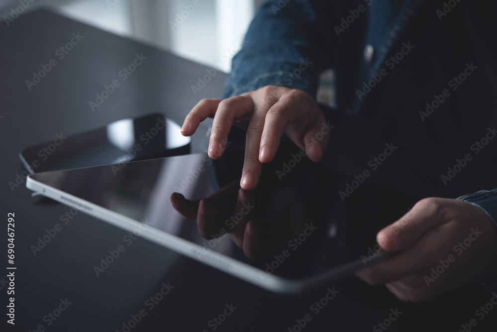 Close up of woman hand using digital tablet, finger touching on screen, reading E-book via E-reader mobile app at office, digital education, online working, freelance at work Close up of woman hand using digital tablet, finger touching on screen, reading E-book via E-reader mobile app at office, digital education, online working, freelance at work