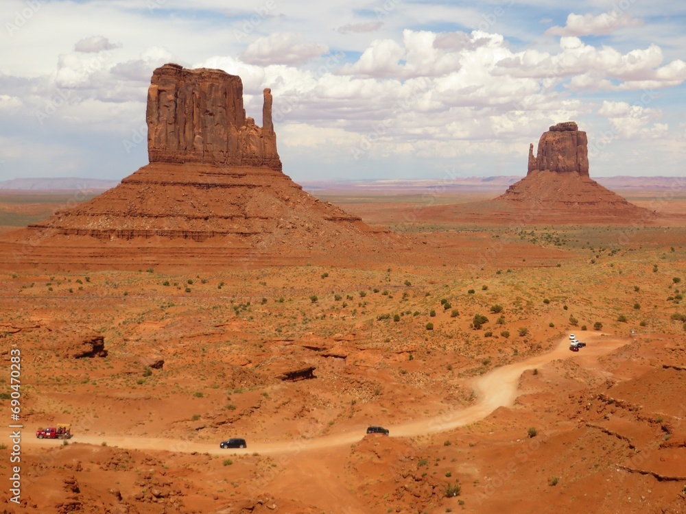 Vehicles Driving Dirt Road in Monument Valley Arizona Utah Vehicles Driving Dirt Road in Monument Valley Arizona Utah