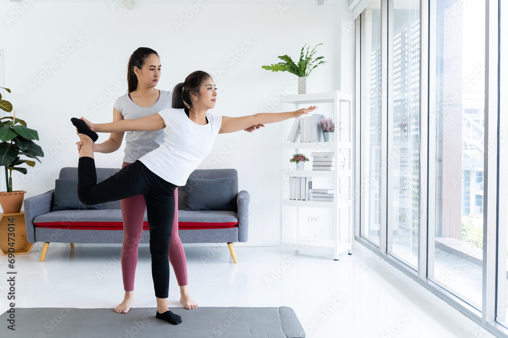 Experienced Teacher Guides Student in Perfecting Pose Experienced Teacher Guides Student in Perfecting Pose