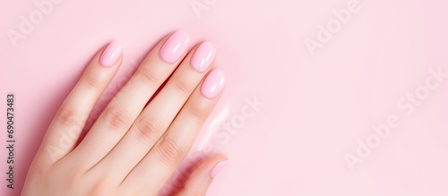 Manicured nails painted pink.
