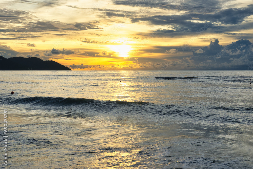 Batu Ferringhi beach and Penang island coastline. Beutiful landscape at sunset. Malaysia. 15.08.2023
