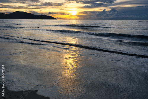 Batu Ferringhi beach and Penang island coastline. Beutiful landscape at sunset. Malaysia. 15.08.2023 photo