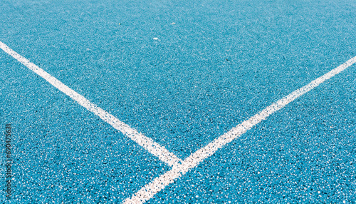 Light blue rubberized and granulated ground surface with white lines