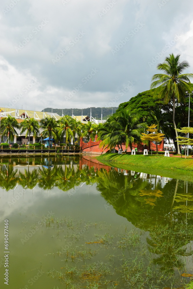 Pond in green park on tropical island. Beautiful nature scenery, place to mind rest. Langkawi, Malaysia - 08.01.2023