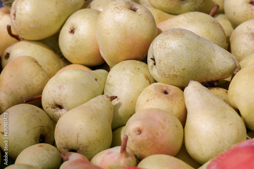 close-up of a pile of pears on a table in a street market  