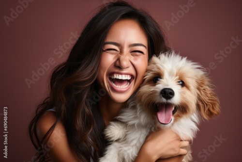 Portrait of a beautiful young girl with her Maltipoo dog, studio photo on a plain background