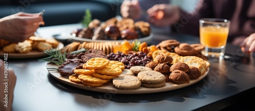 Closeup of people enjoying various snacks near a table during a coffee break. photo