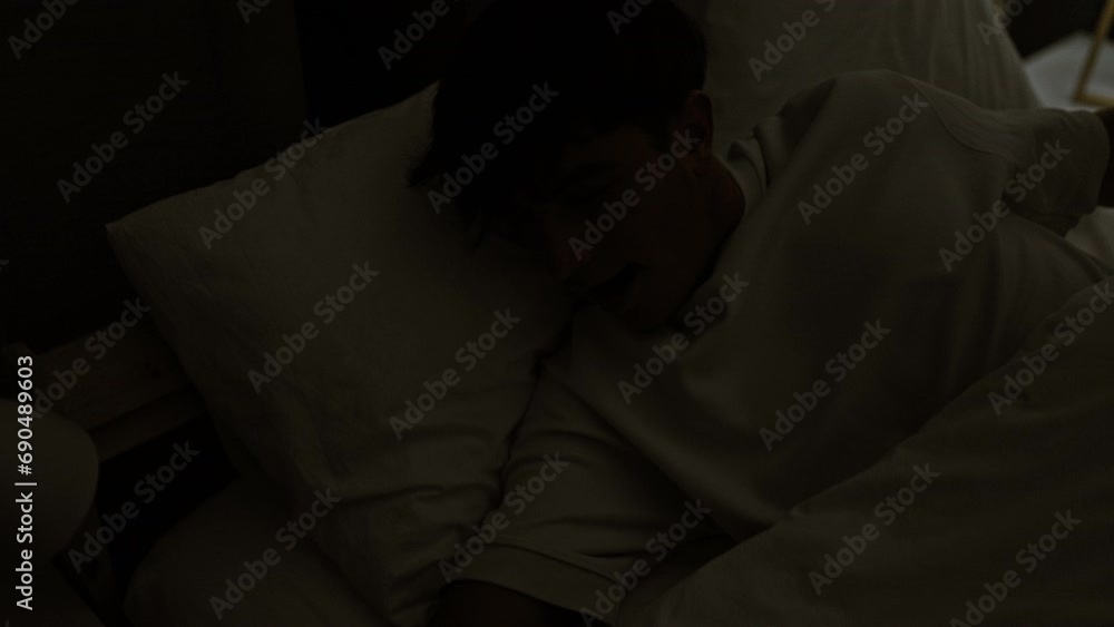 Happy young hispanic teenager stretching arms in comfort of his morning bed, waking up confidently in a well-lit bedroom Happy young hispanic teenager stretching arms in comfort of his morning bed, waking up confidently in a well-lit bedroom