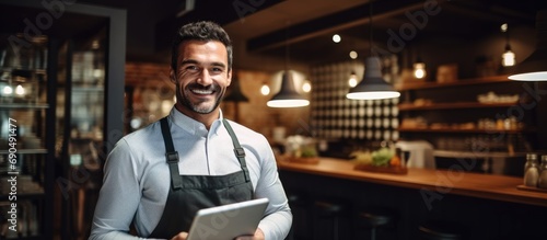 Restaurant man using tablet for inventory check, small business entrepreneur in hospitality industry. Male owner handling cafe franchise, digital admin and stock taking with connectivity. photo