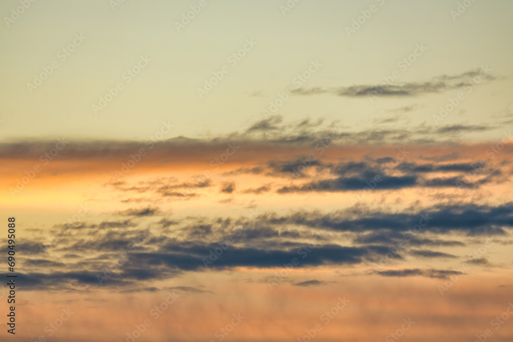 A beautiful sky tinted by the sun leaving vibrant shades of gold, pink, blue and multicolored. Clouds in the twilight evening and morning sky. Image of a cloudy sky in the evening and during the day