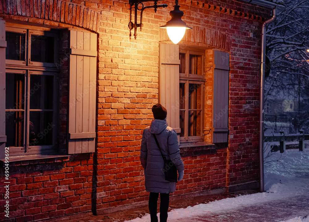 Night street background with lantern on and person under it