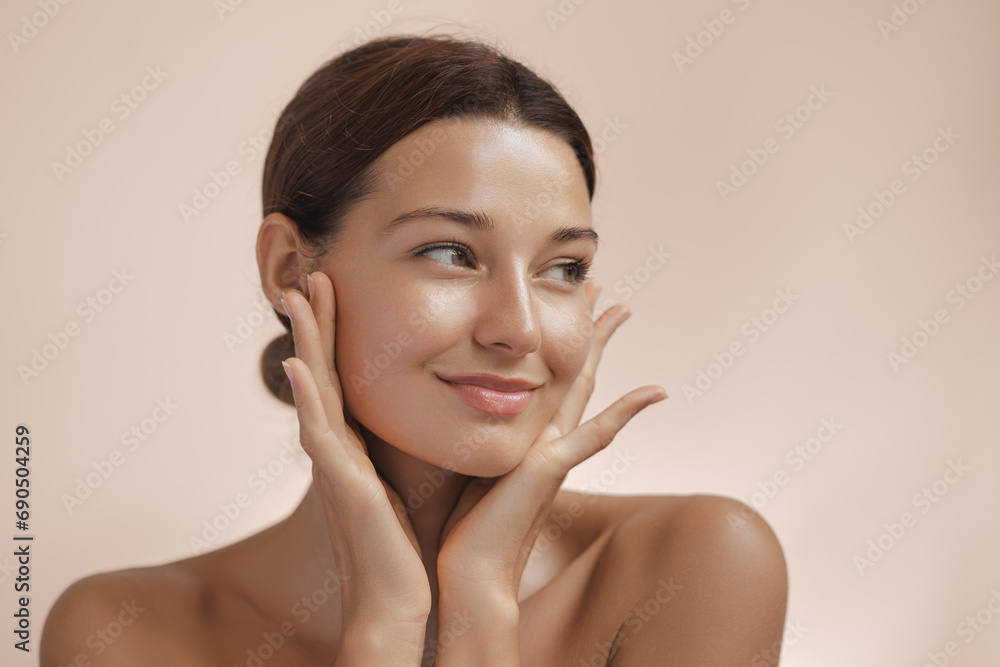 Happy beautiful young adult woman showing her perfect face with healthy shiny skin. Beauty photo of gorgeous girl after morning beauty cosmetic routine finishes daily makeup on pink background. Youth - obrazy, fototapety, plakaty 